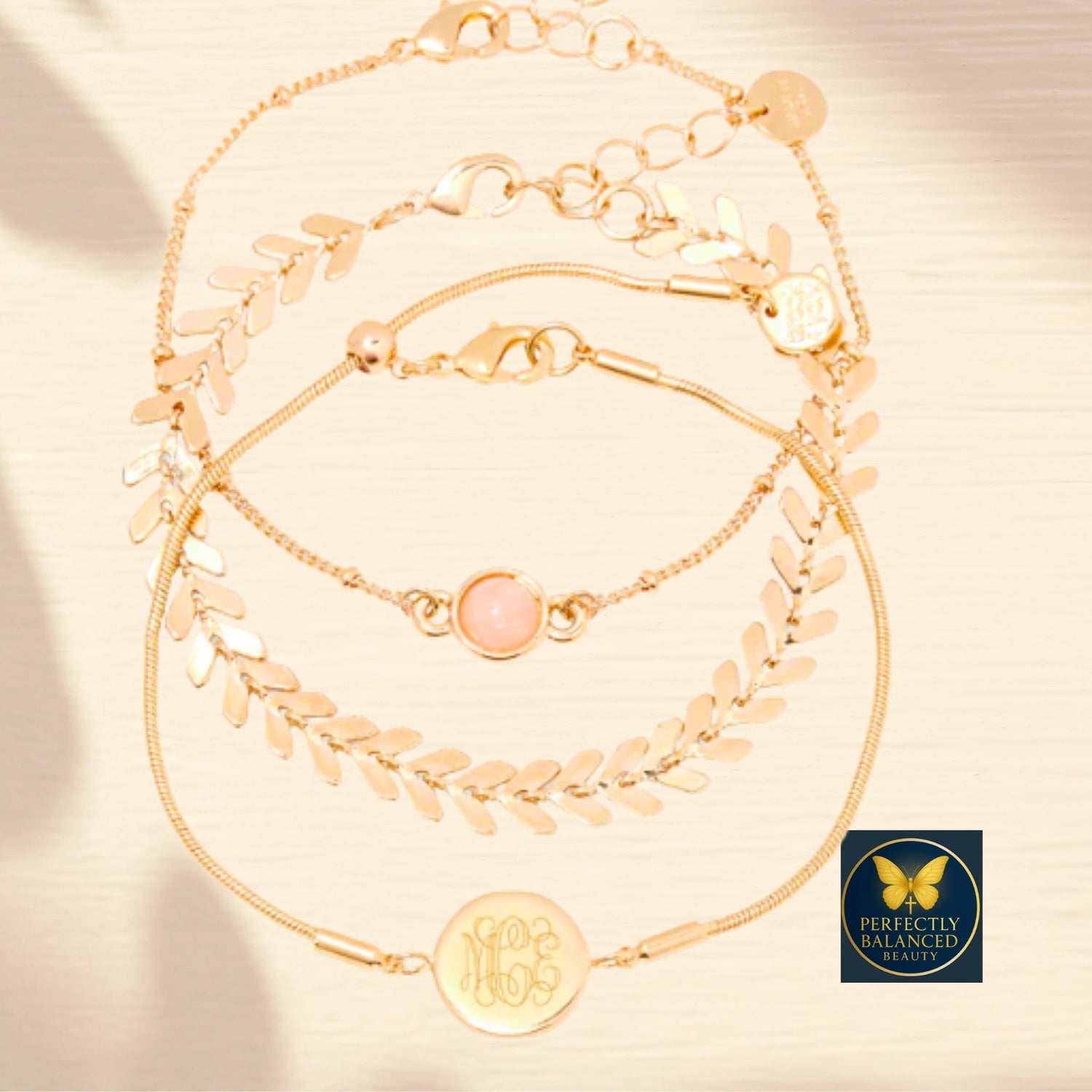 Layered gold faith-inspired bracelets and anklets with charm and laurel designs, symbolizing grace and divine balance – Perfectly Balanced Beauty jewelry collection.